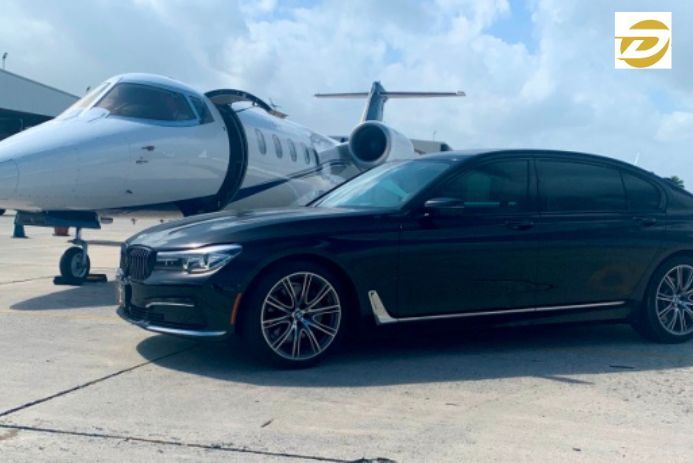 Luxury private car service with chauffeur waiting at DFW Airport in Dallas