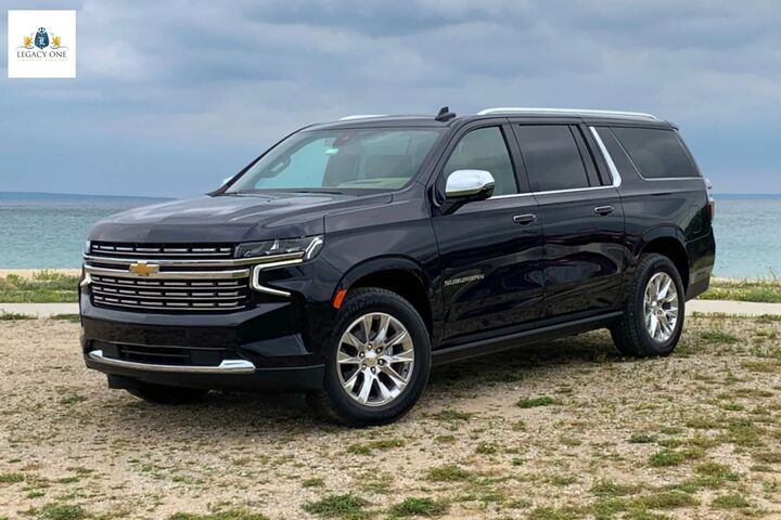  “Luxury SUV used for black car service in Dallas, driving toward Reunion Tower in the city skyline.”